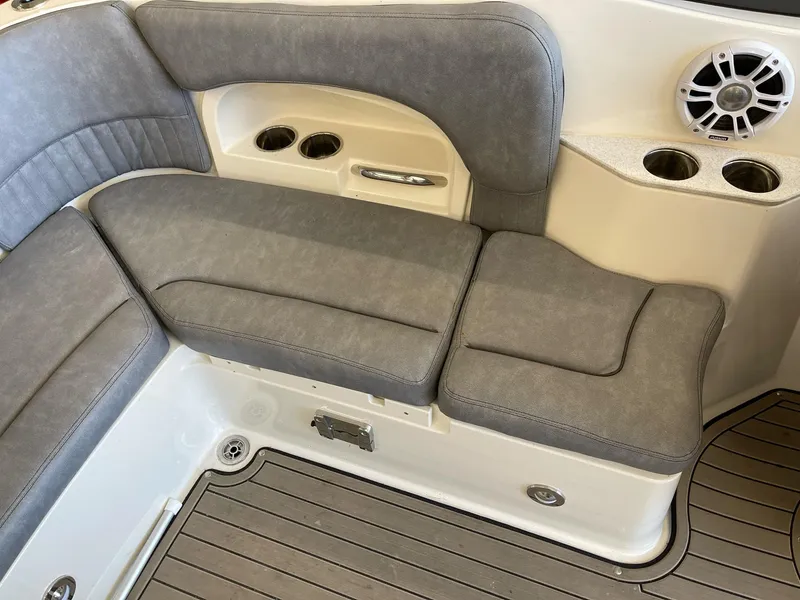 Slide: The Image of 2022 Stingray 231 DC boat interior with gray seating, cup holders, and speaker. - 9