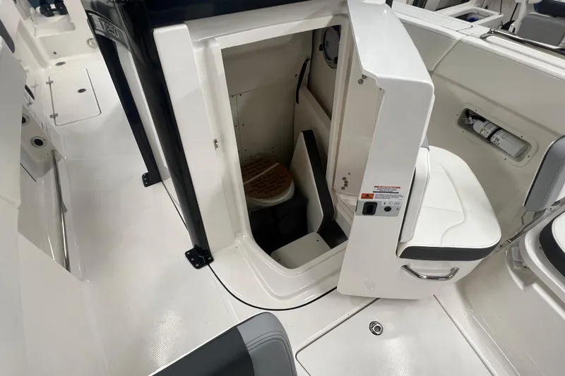 Slide: The Image of 2025 Robalo R250 Center Console dashboard with dual displays and steering wheel. - 11