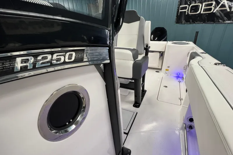 Slide: The Image of 2025 Robalo R250 Center Console boat interior with open storage compartment. - 14