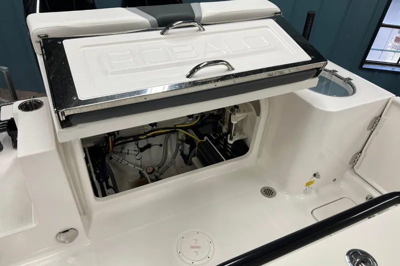 Slide: The Image of 2025 Robalo R250 Center Console boat interior with open storage compartments and seating. - 15