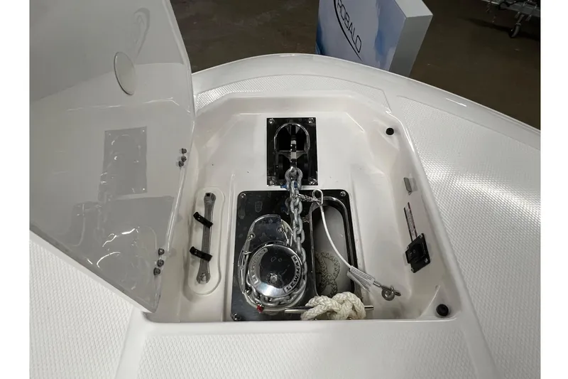 Slide: The Image of 2025 Robalo R250 Center Console anchor compartment with chain and rope storage. - 21