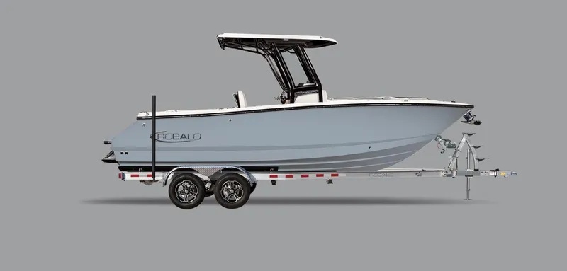 Slide: The Image of 2025 Robalo R250 Center Console boat on trailer, side view, gray background. - 22