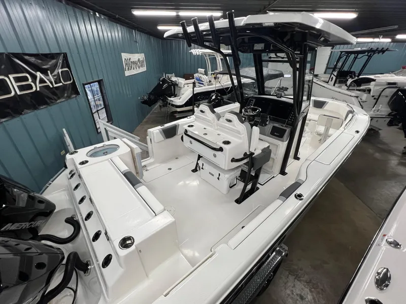Slide: The Image of 2025 Robalo R250 Center Console boat in showroom, featuring spacious deck and modern design. - 3