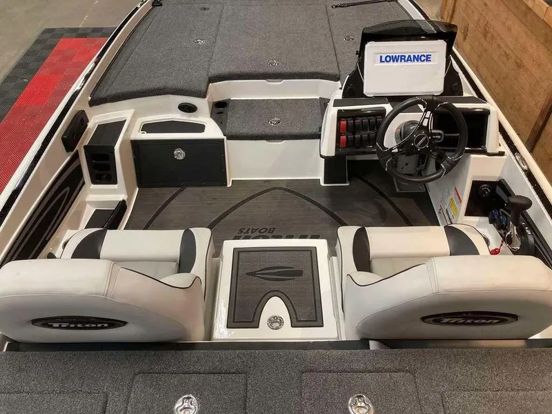 Slide: The Image of 2024 Triton 20XP boat interior with dual seats, steering console, and Lowrance electronics. - 4