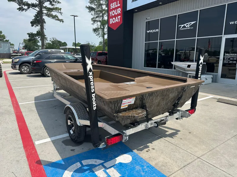 Slide: The Image of 2025 Xpress HD16DBX boat on trailer outside dealership, parked in handicap spot. - 10