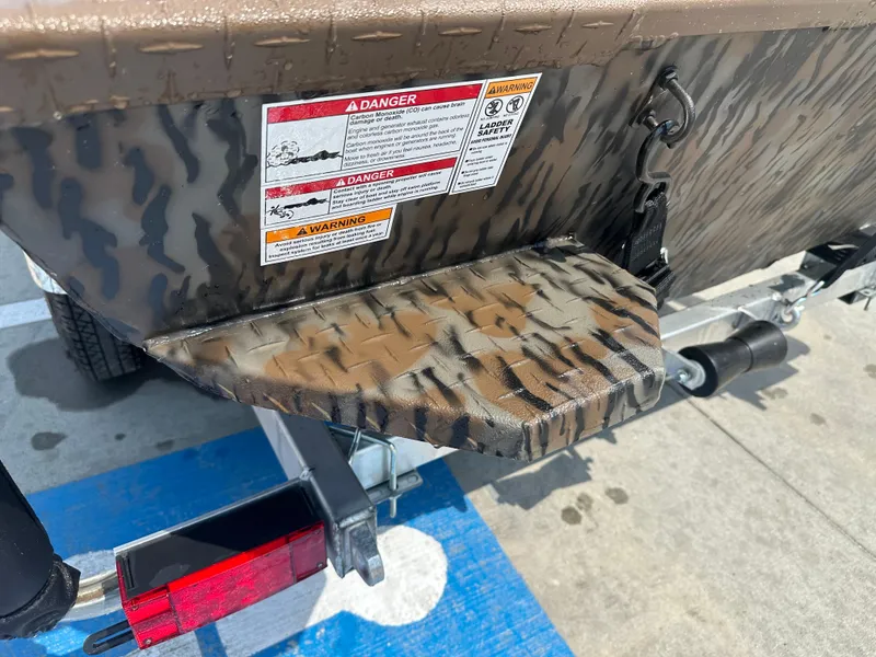 Slide: The Image of 2025 Xpress HD16DBX boat with camouflage pattern and safety warnings. - 11