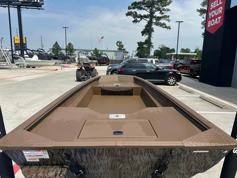 Slide: The Image of 2025 Xpress HD16DBX boat displayed outdoors at a dealership. - 12