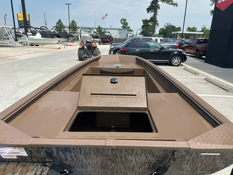 Slide: The Image of 2025 Xpress HD16DBX boat in parking lot, open storage compartments, surrounded by vehicles. - 13