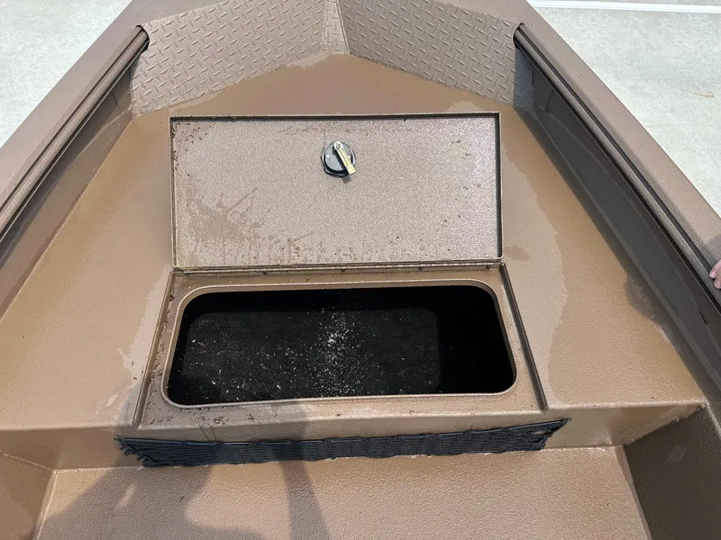 Slide: The Image of 2025 Xpress HD16DBX boat storage compartment with open hatch, showing interior space. - 16
