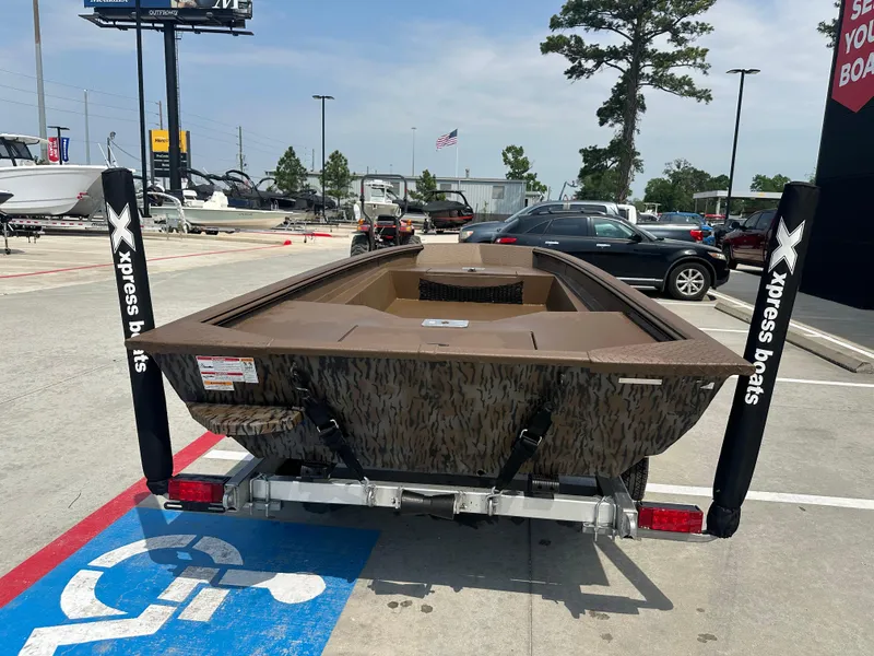 Slide: The Image of 2025 Xpress HD16DBX boat on trailer in parking lot, surrounded by cars and trees. - 9