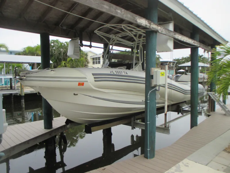 The Image of 2021 Zodiac NZO 760 boat docked under a covered marina. - 0