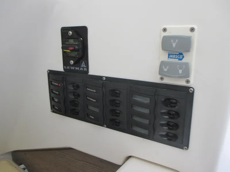 Slide: The Image of Control panel on a 2021 Zodiac NZO 760 boat featuring Lewmar and Jabsco switches. - 13