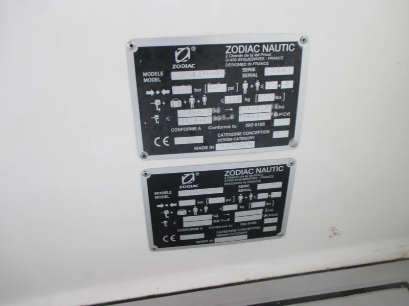 Slide: The Image of Zodiac NZO 760 2021 model identification plates on a white surface. - 14