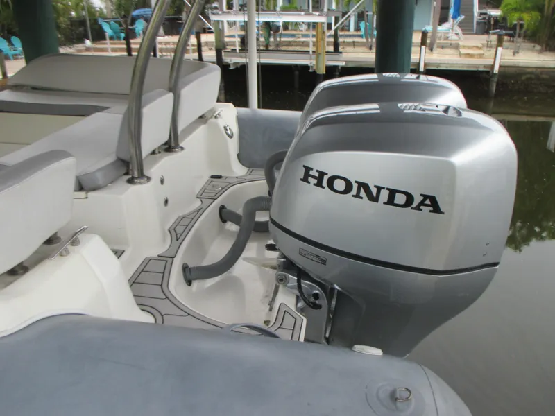 Slide: The Image of 2021 Zodiac NZO 760 boat with Honda outboard motor, docked in a marina. - 3