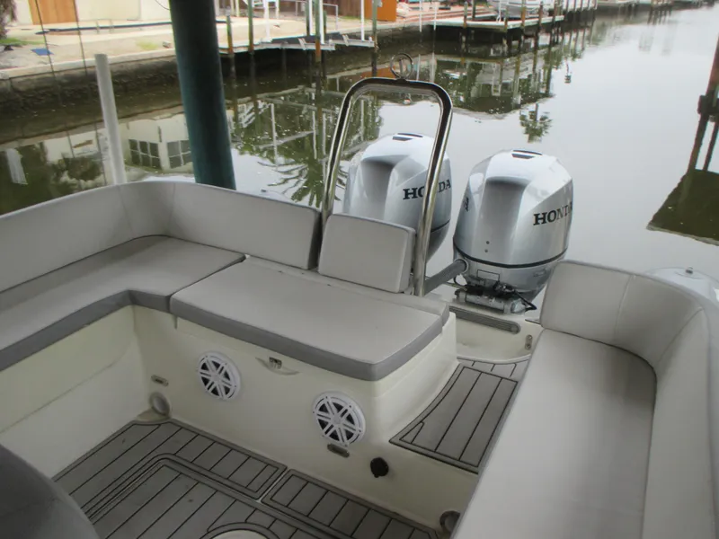 Slide: The Image of 2021 Zodiac NZO 760 boat interior with Honda outboard motors, docked by calm water. - 7