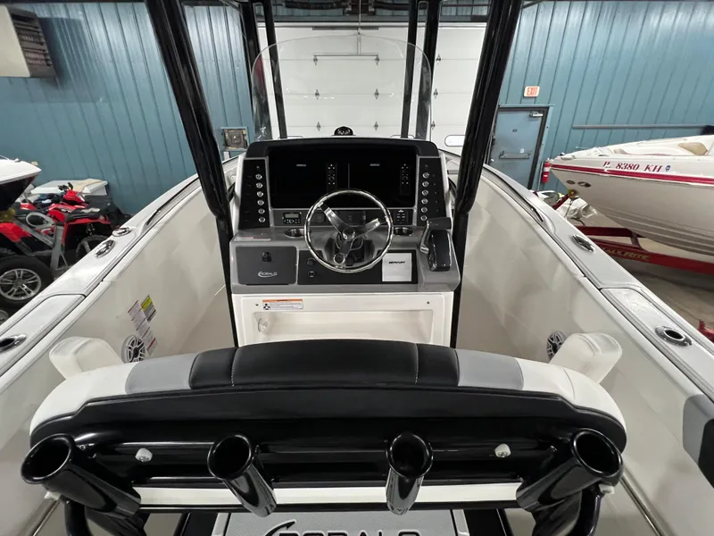 Slide: The Image of 2025 Robalo R230 Center Console boat interior with steering wheel and control panel. - 10