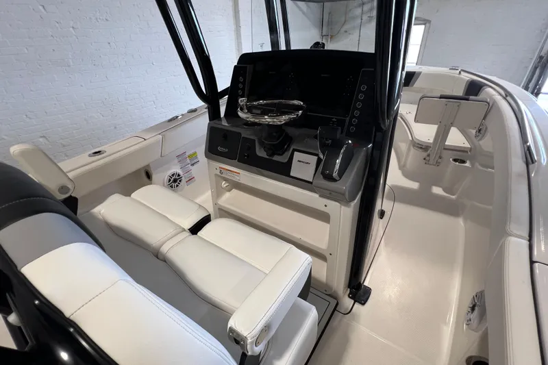 Slide: The Image of 2025 Robalo R230 Center Console boat interior with modern helm and seating. - 11