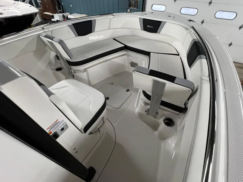 Slide: The Image of 2025 Robalo R230 Center Console boat interior with white seating and storage compartments. - 14