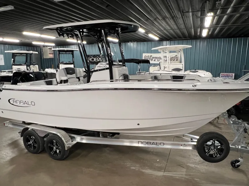 Slide: The Image of 2025 Robalo R230 Center Console boat on trailer in showroom. - 19