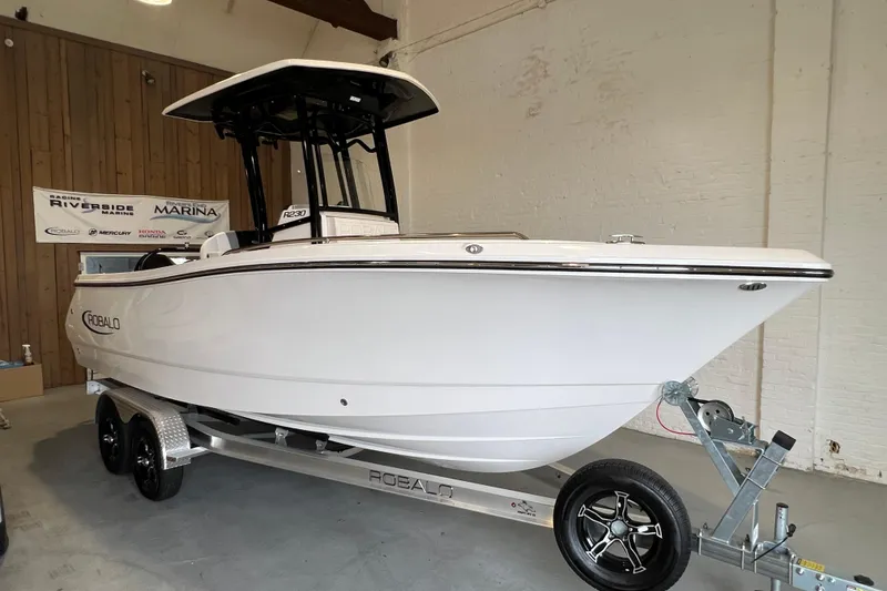 Slide: The Image of 2025 Robalo R230 Center Console boat on trailer in showroom. - 20