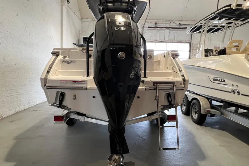 Slide: The Image of 2025 Robalo R230 Center Console boat with powerful V8 engine in showroom. - 5