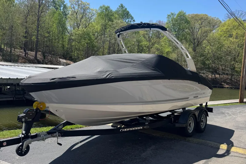 The Image of 2024 Chaparral 21 SSi boat with cover on trailer. - 1
