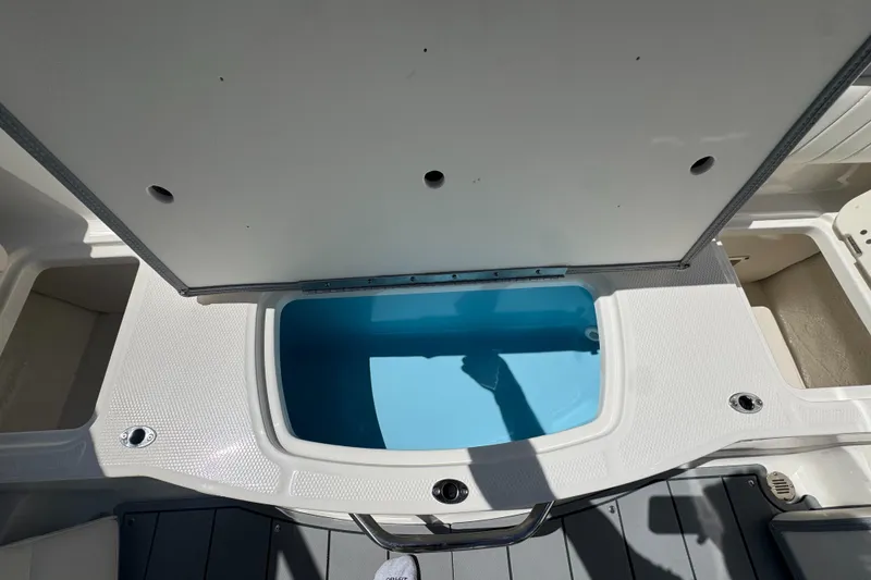 Slide: The Image of 2024 Chaparral 21 SSi boat with open storage compartment. - 13