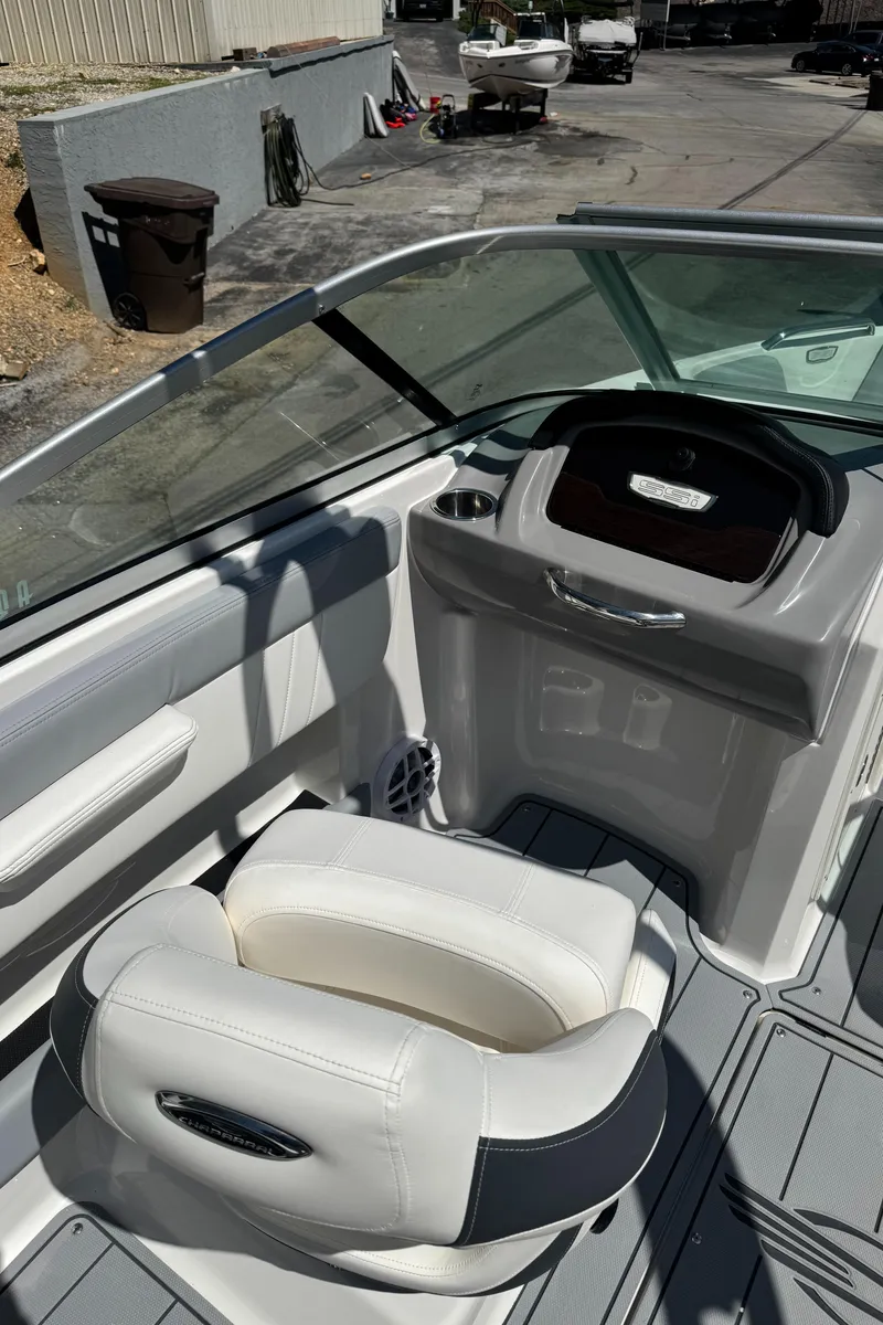 Slide: The Image of Interior of 2024 Chaparral 21 SSi with white seat and helm console. - 16
