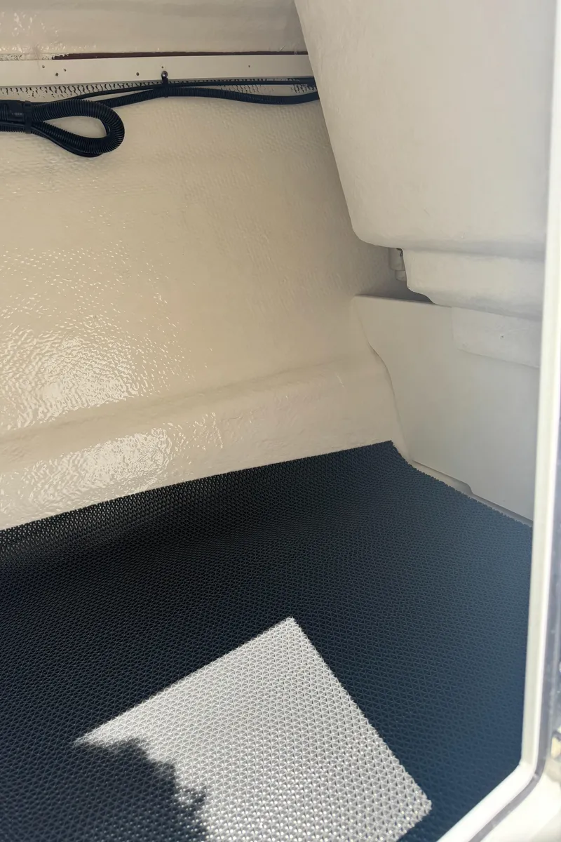 Slide: The Image of Interior of 2024 Chaparral 21 SSi boat, featuring white and black design. - 22