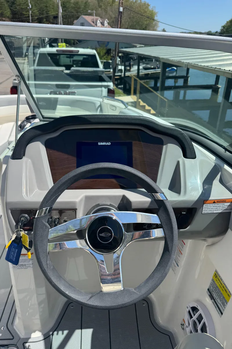 Slide: The Image of Interior view of 2024 Chaparral 21 SSi boat cockpit with steering wheel. - 27