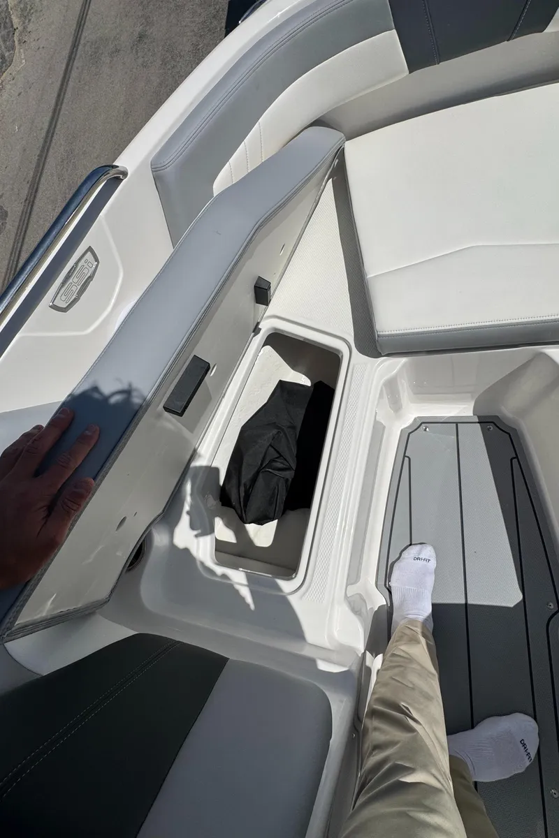 Slide: The Image of 2024 Chaparral 21 SSi boat with open storage compartment in bow area. - 31