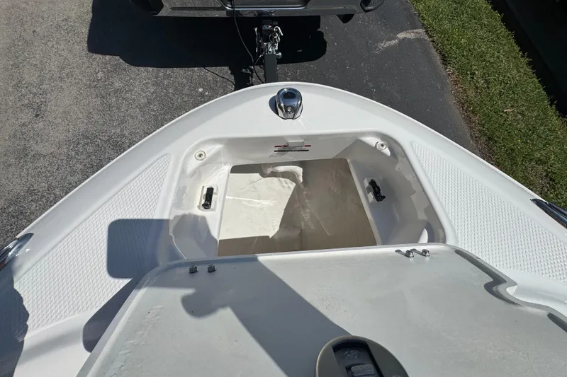 Slide: The Image of 2024 Chaparral 21 SSi boat with open storage compartment. - 32