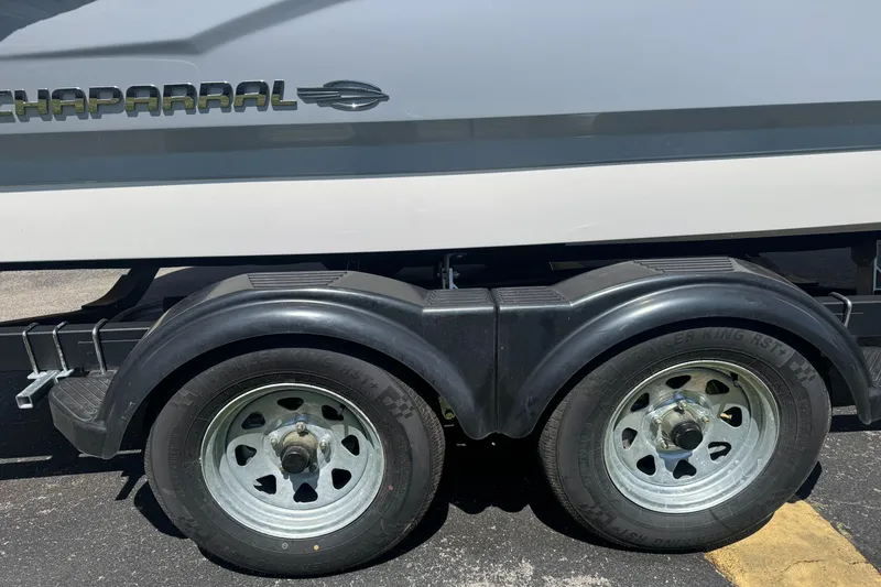 Slide: The Image of 2024 Chaparral 21 SSi boat trailer with dual axles on asphalt. - 40