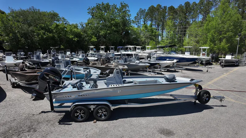 Slide: The Image of 2025 Xpress H22B boat on trailer in a lot with multiple boats. - 11