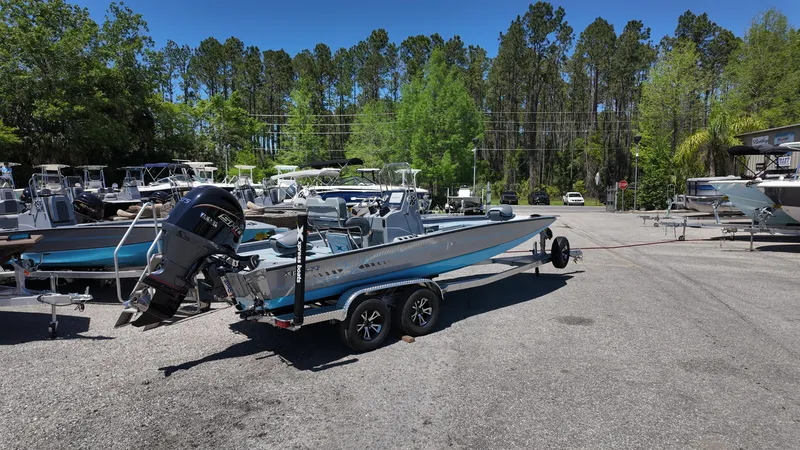 Slide: The Image of 2025 Xpress H22B boat on trailer in outdoor dealership lot. - 16