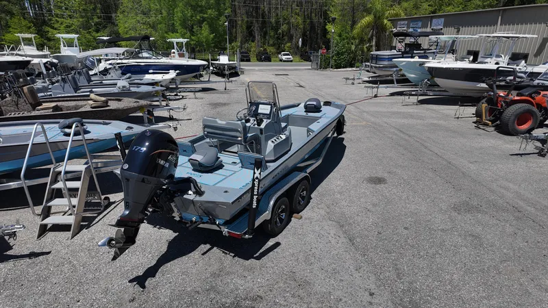 Slide: The Image of 2025 Xpress H22B boat on trailer in outdoor showroom with other boats. - 20