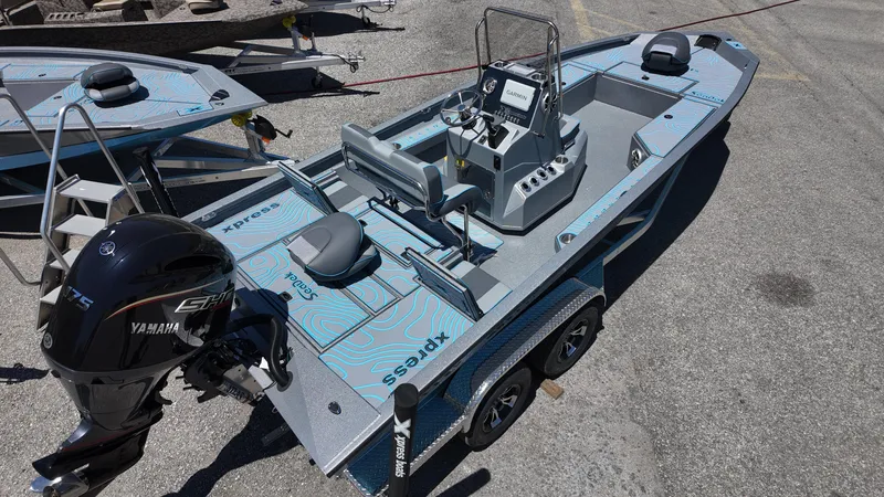 Slide: The Image of 2025 Xpress H22B boat with Yamaha engine on trailer, viewed from above. - 21