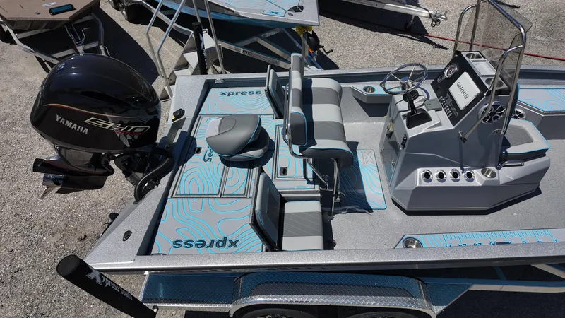 Slide: The Image of 2025 Xpress H22B boat interior with Yamaha engine, featuring seating and control console. - 22