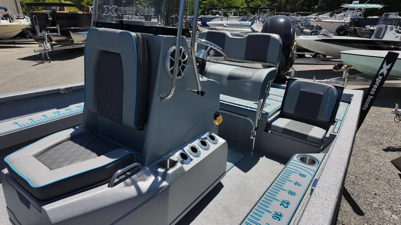 Slide: The Image of 2025 Xpress H22B boat interior with seating and measuring ruler on deck. - 29