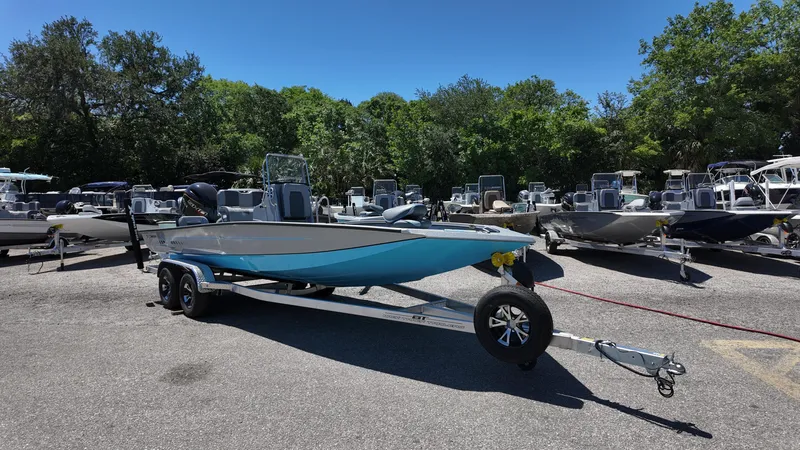 Slide: The Image of 2025 Xpress H22B boat on trailer in a sunny outdoor showroom. - 3
