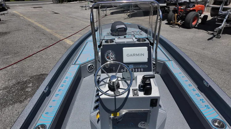 Slide: The Image of 2025 Xpress H22B boat with Garmin navigation, steering wheel, and console controls. - 32