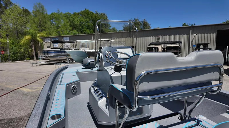 Slide: The Image of 2025 Xpress H22B boat with sleek design, parked outdoors under clear blue sky. - 33