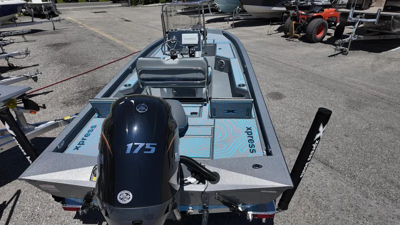 Slide: The Image of 2025 Xpress H22B boat with 175 horsepower engine, parked on a trailer. - 34