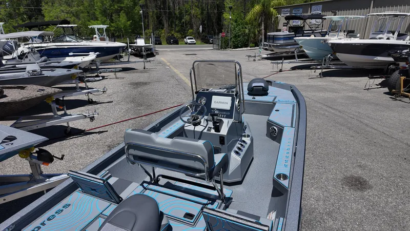 Slide: The Image of 2025 Xpress H22B boat in a dealership lot, showcasing sleek design and modern features. - 35
