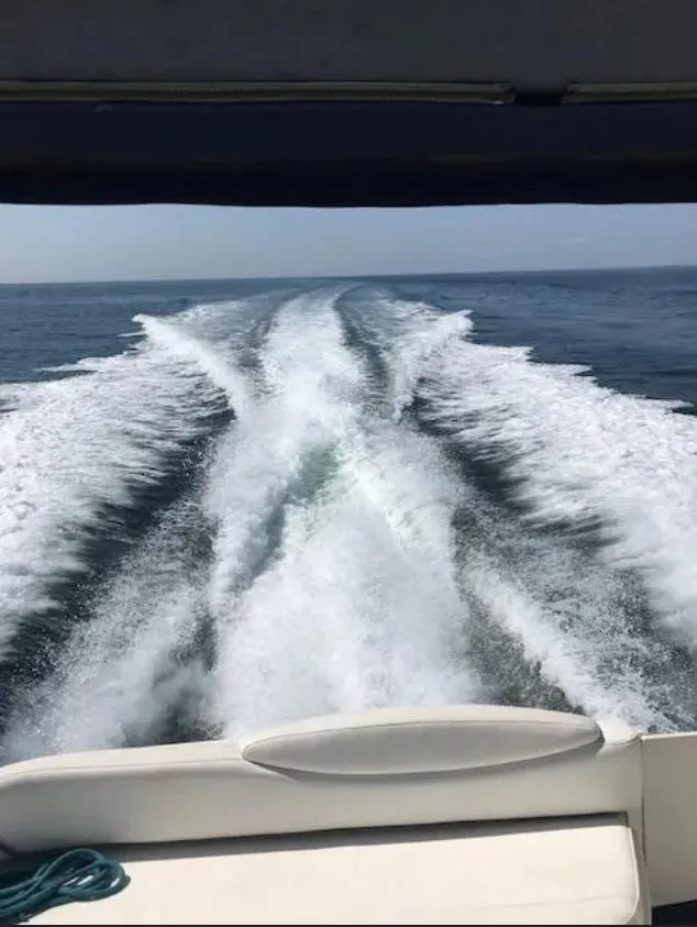 Slide: The Image of Wake trail behind 2002 Sea Ray 340 Sundancer on open water. - 14