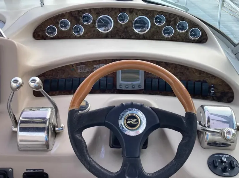 Slide: The Image of 2002 Sea Ray 340 Sundancer helm with gauges, steering wheel, and controls. - 3