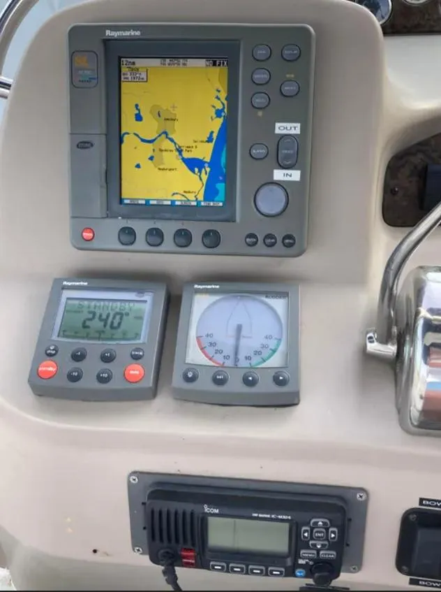 Slide: The Image of Control panel of a 2002 Sea Ray 340 Sundancer with navigation and communication equipment. - 5