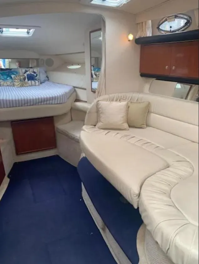 Slide: The Image of Interior of 2002 Sea Ray 340 Sundancer with cozy seating and bed area. - 6