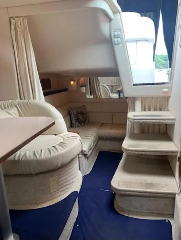 Slide: The Image of Interior of 2002 Sea Ray 340 Sundancer yacht with cozy seating and stairs. - 8