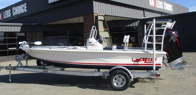 The Image of 2025 Mako 18 Pro Skiff Patriot Edition on trailer outside dealership. - 1